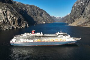 Fred. Olsen cruise ship cruising through dramatic fjords in Norway as part of a world cruise segment